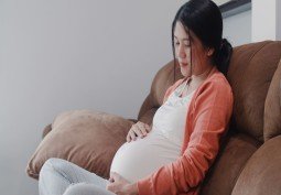 young-asian-pregnant-woman-holding-her-belly-talking-with-her-child-mom-feeling-happy-smiling-positive-peaceful-while-take-care-baby-pregnancy-lying-sofa-living-room-home (1) (1)